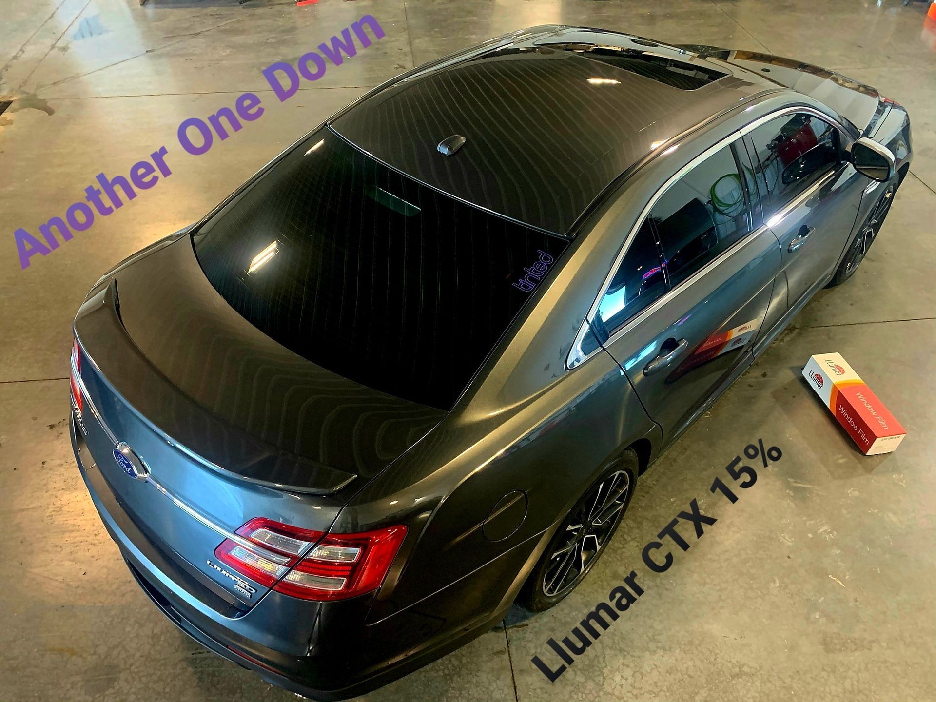 A black car with another one down written on it