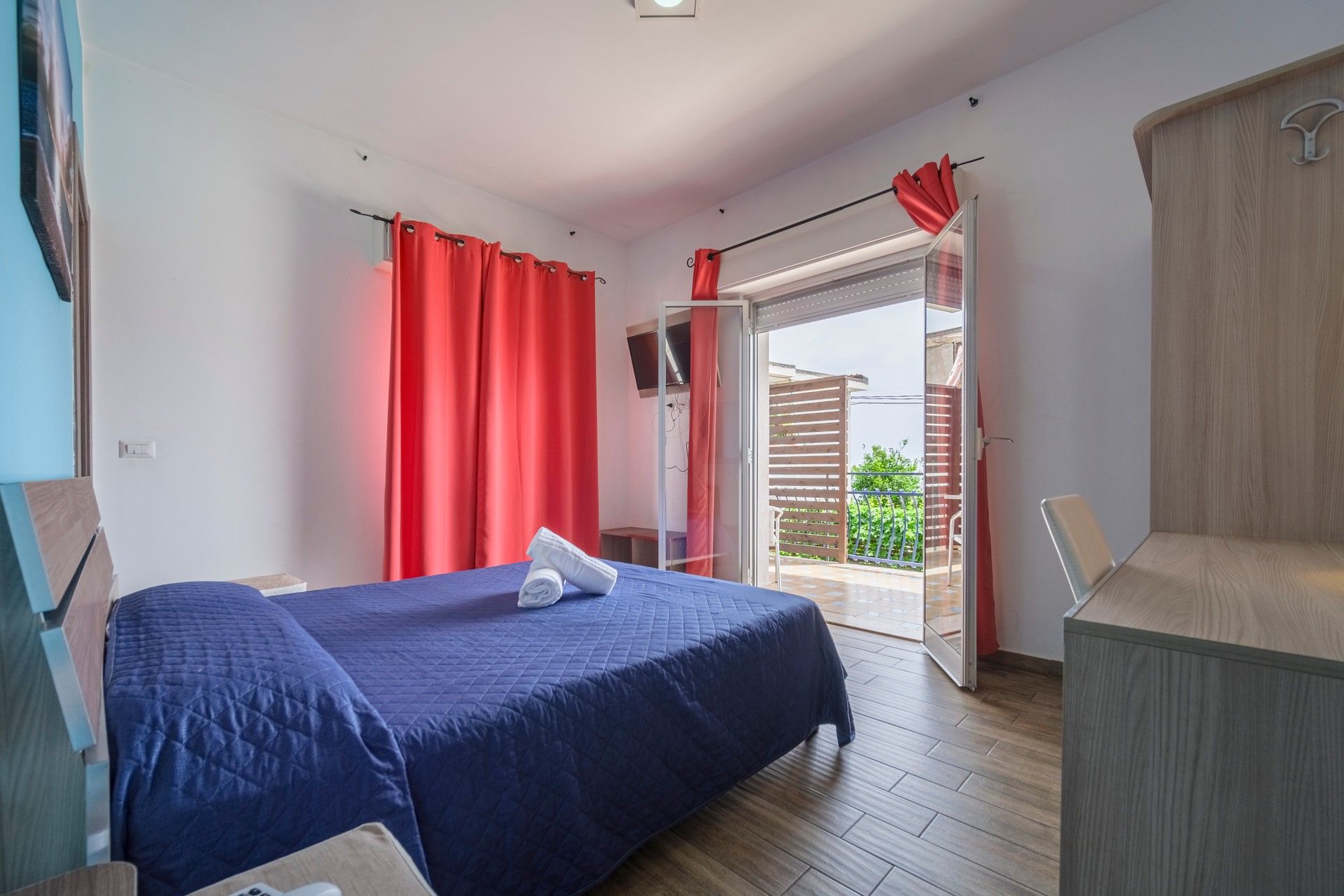 Una camera da letto con un letto grande e tende rosse.