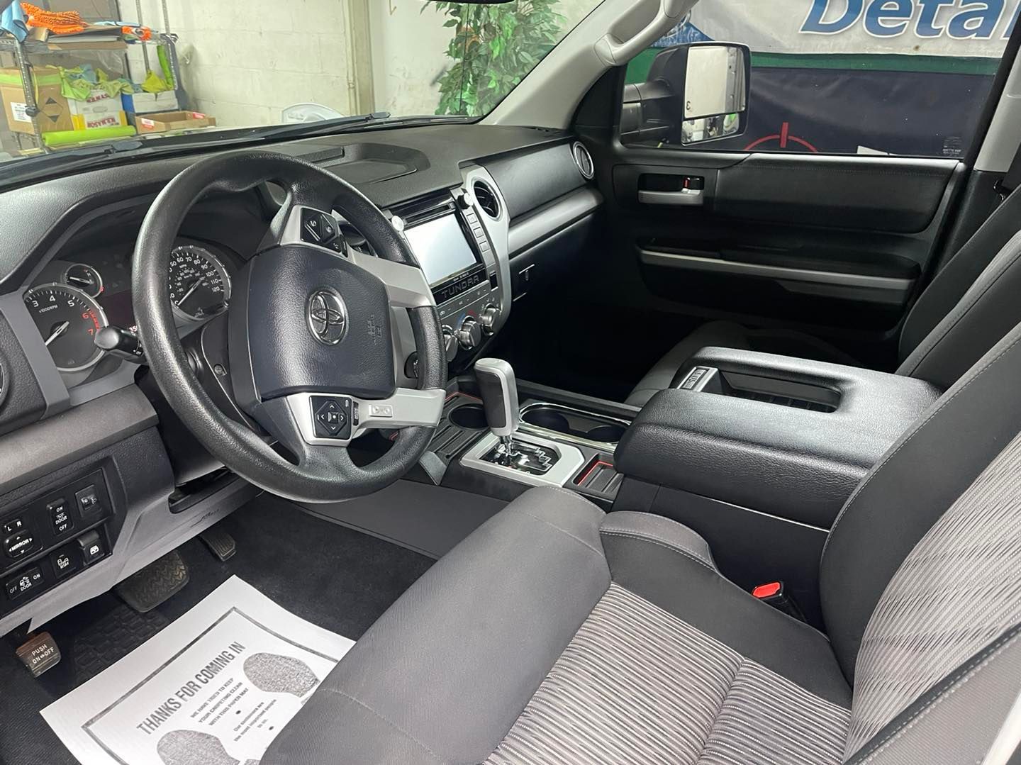 the interior of a toyota tundra truck with a steering wheel and seats .