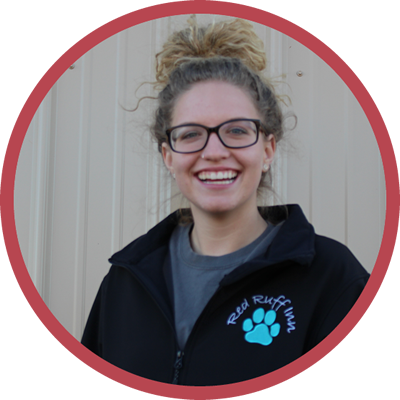 A woman wearing glasses and a black jacket that says red ruff team