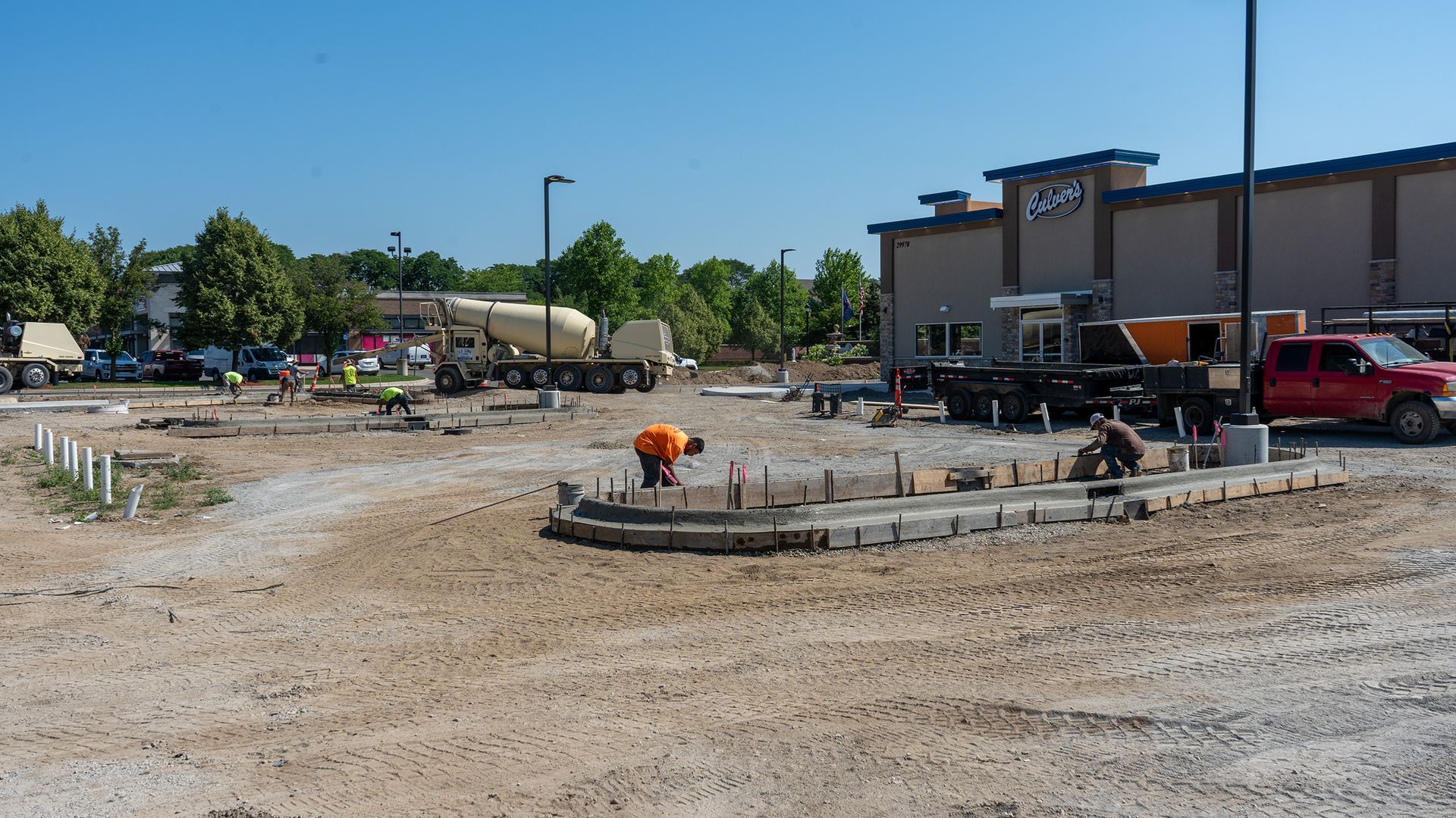 A construction site with a large building in the background