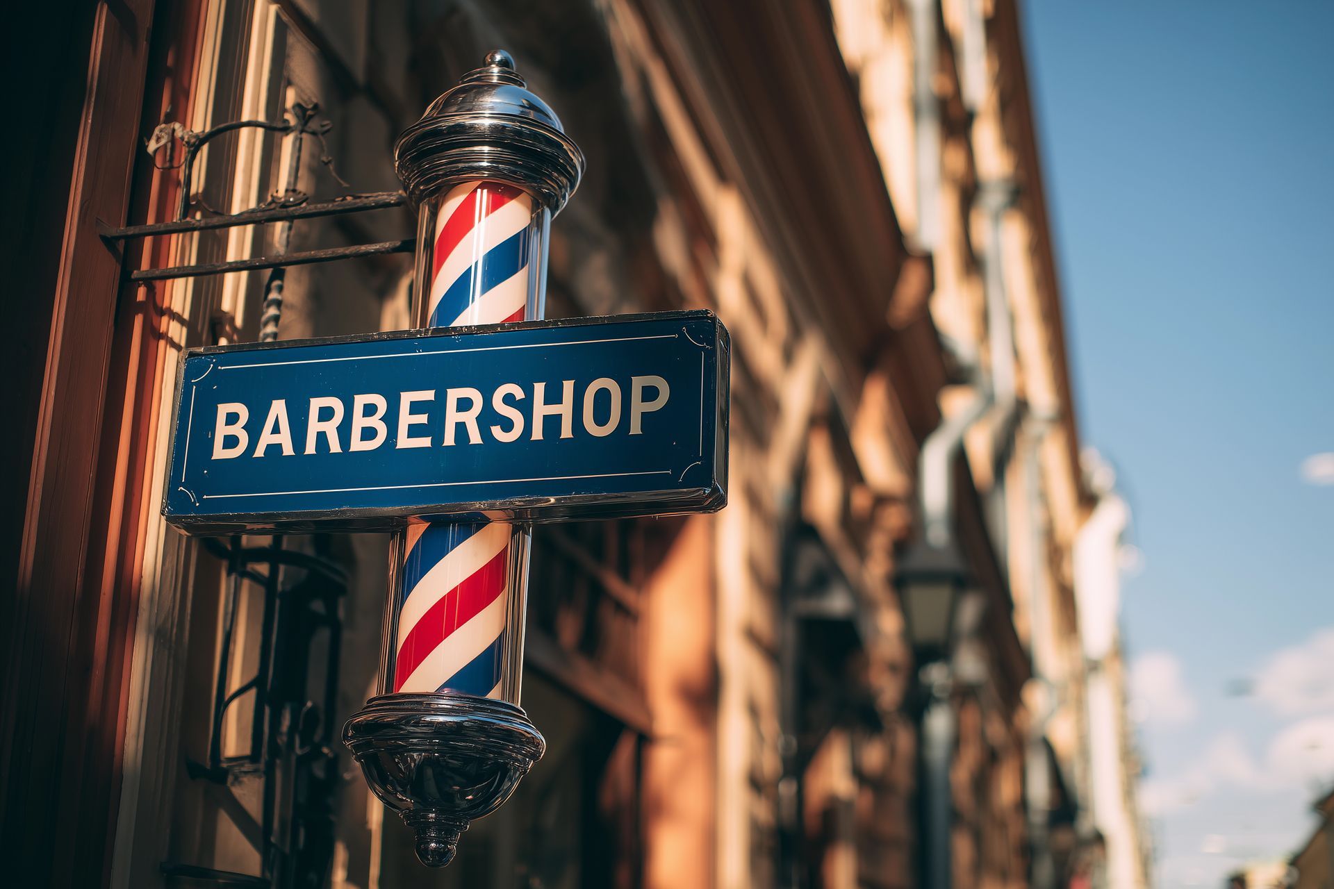 Barbershop sign with red, white, and blue striped pole on a building facade.
