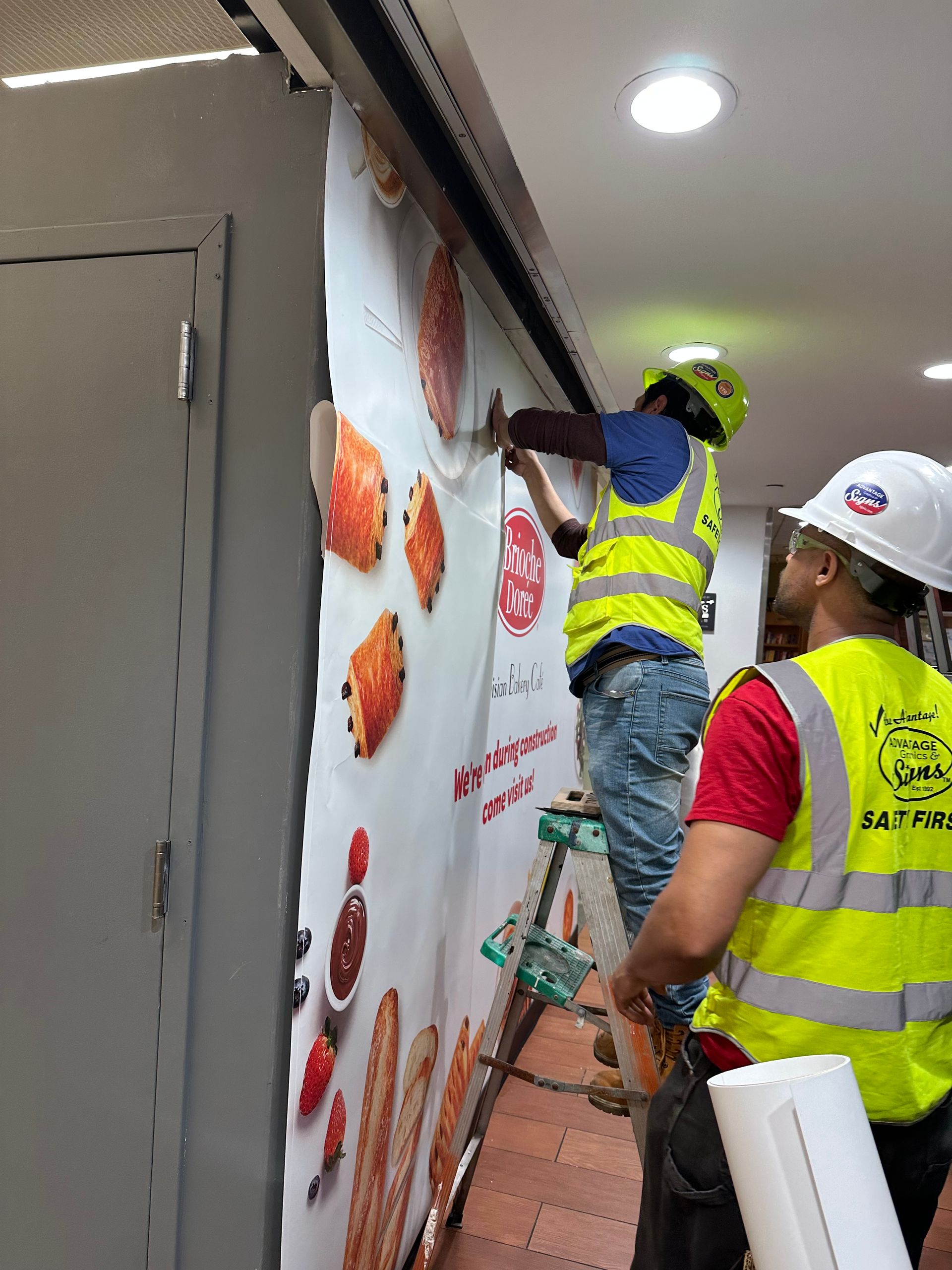 A group of construction workers are working on a wall.