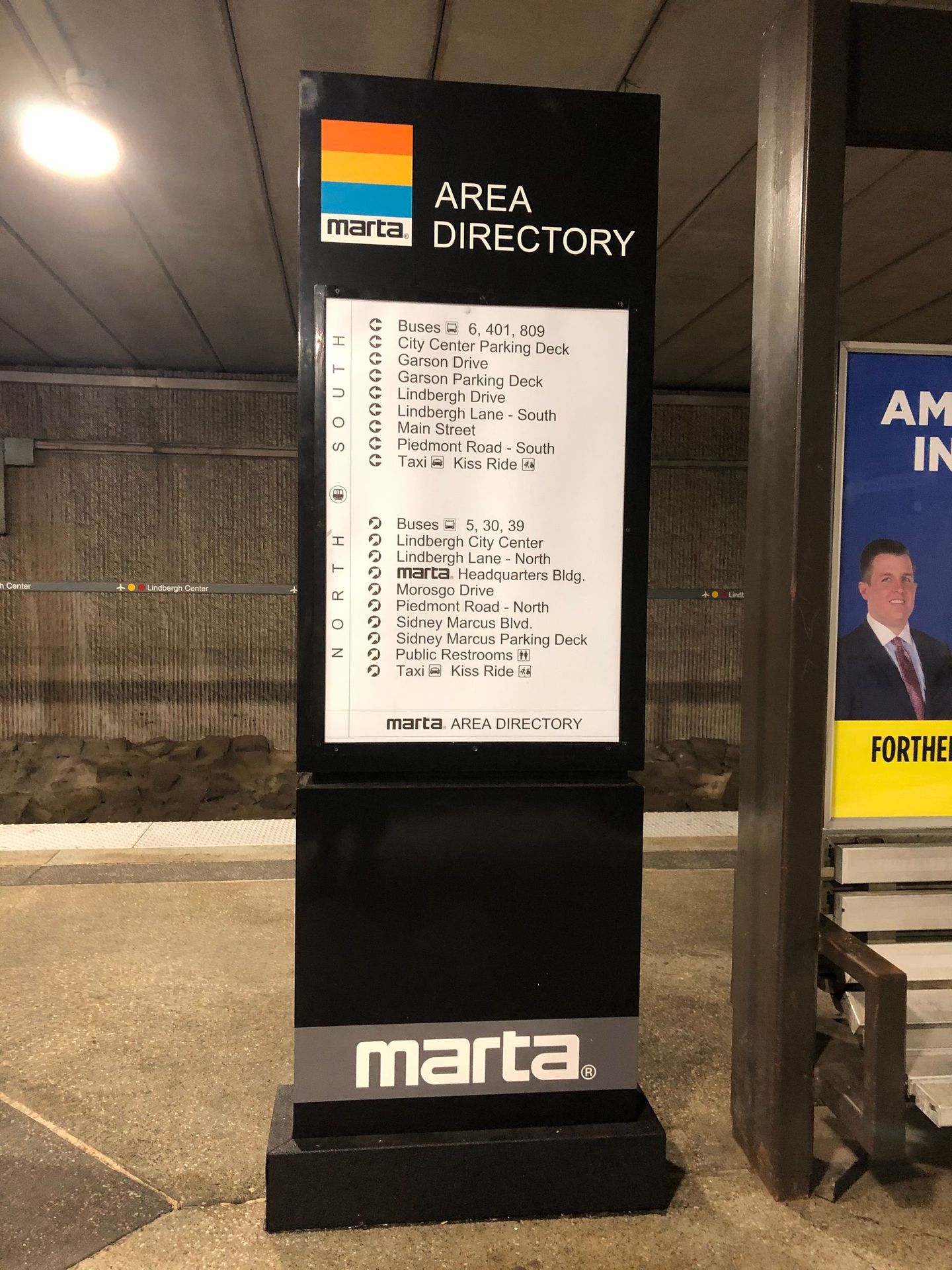 MARTA area directory sign with list of locations, black with orange, blue, gray logo.