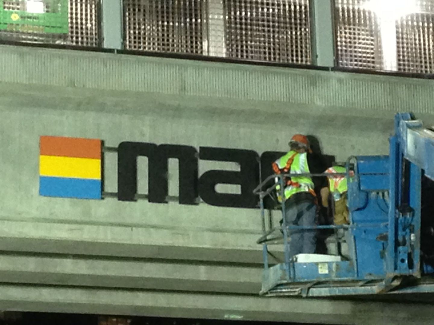 Workers in a lift installing a 