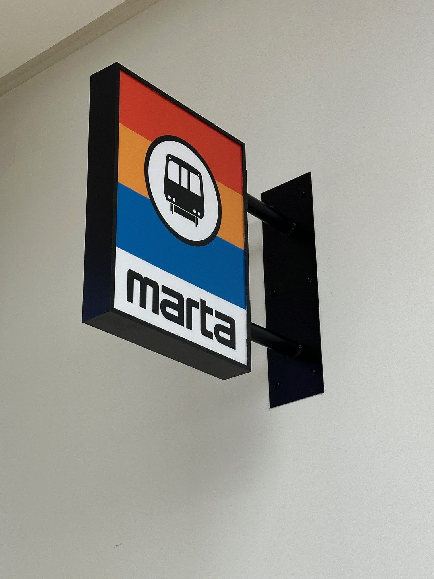 A sign on a wall that says marta on it