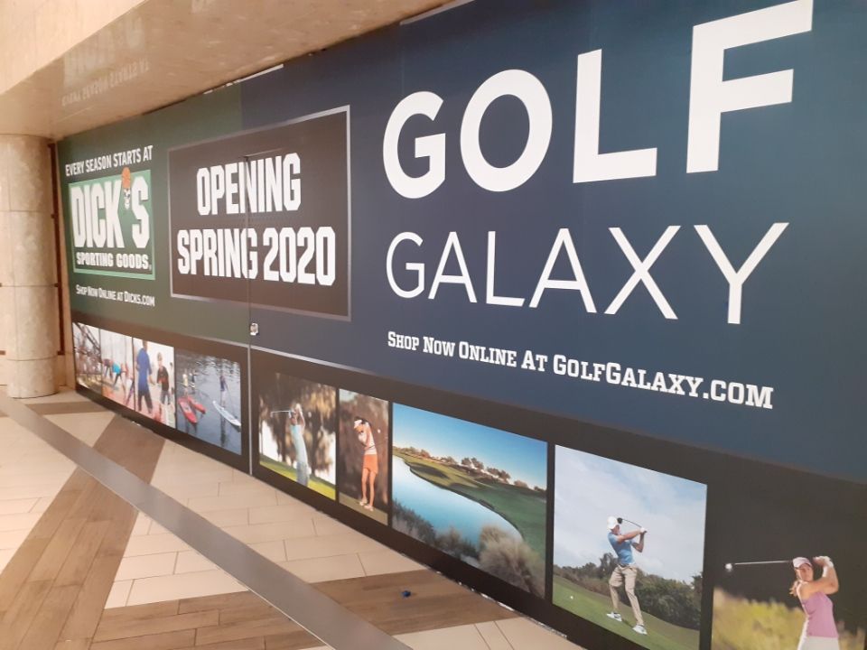 Golf Galaxy store opening Spring 2020, by Dick's Sporting Goods. Blue, white, and green signage with golf-themed photos.