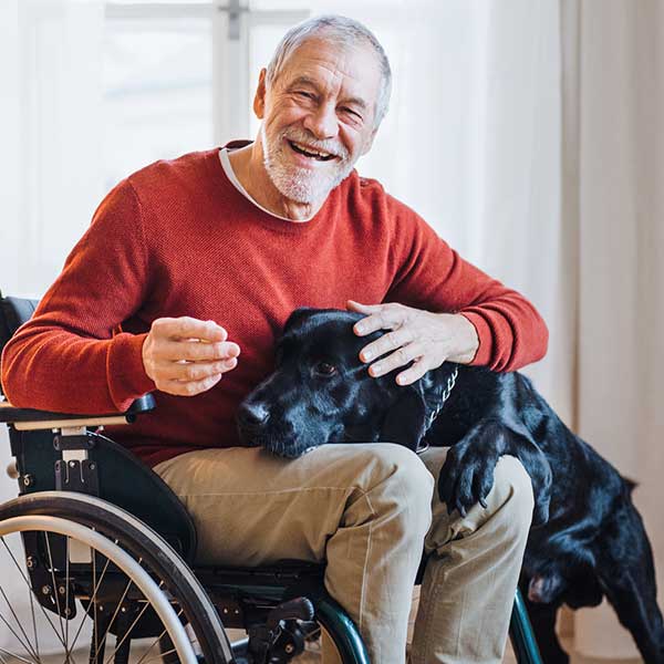 Disability And Benefits — Senior Man Holding A Dog In Clearwater, FL