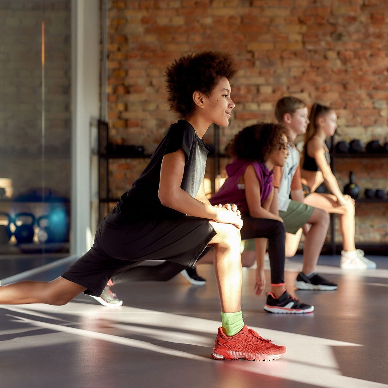 Image of adolescents at the gym exercising together.