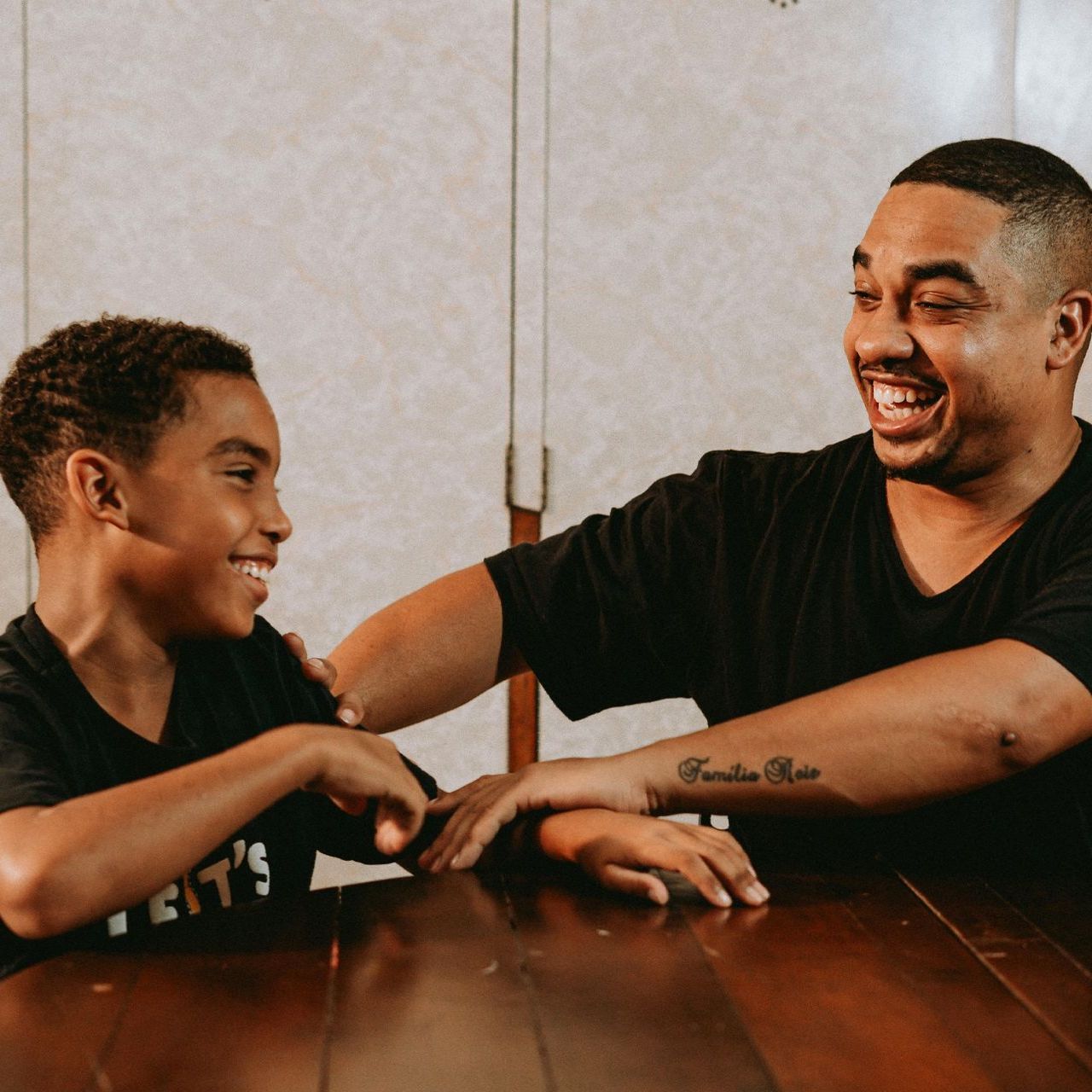 Image of father and son laughing at a joke.