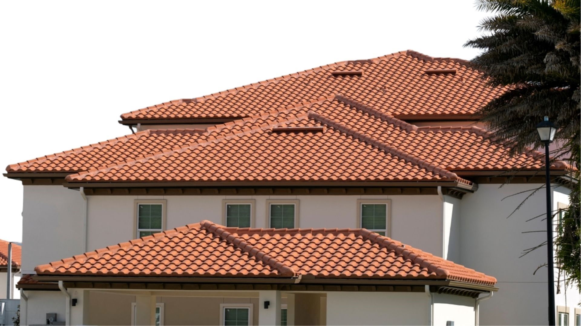 Professional roofer assessing storm-related roof damage on a home