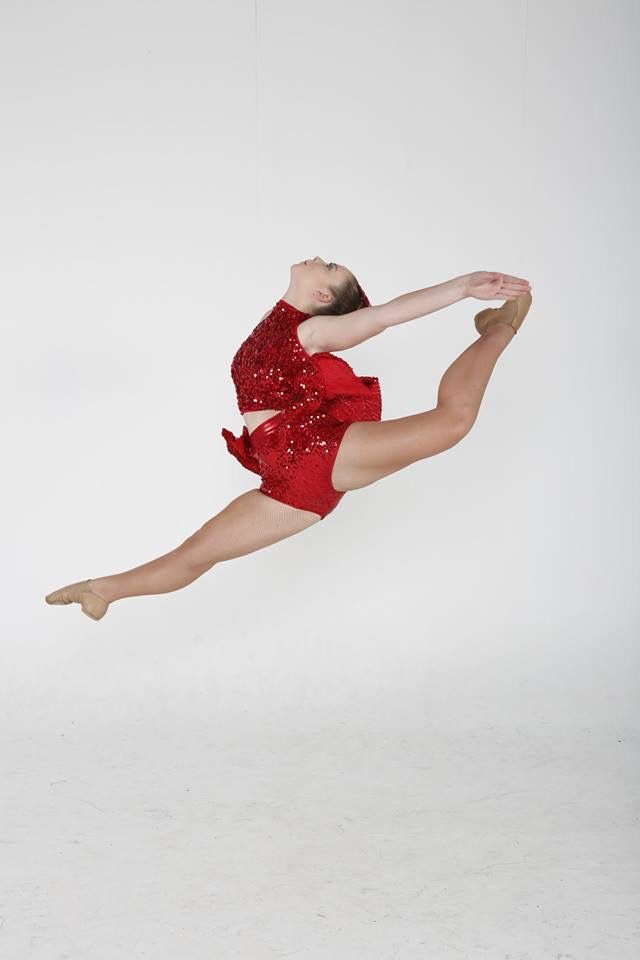 A Young Girl in a Red Dress is Jumping in the Air — Studi-O Dance School In Gateshead, NSW
