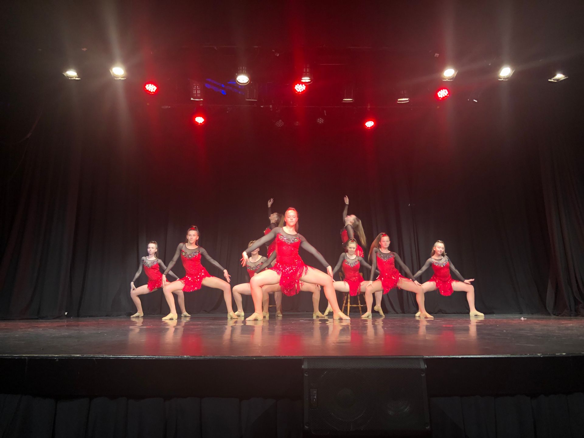 A group of dancers are performing on a stage.