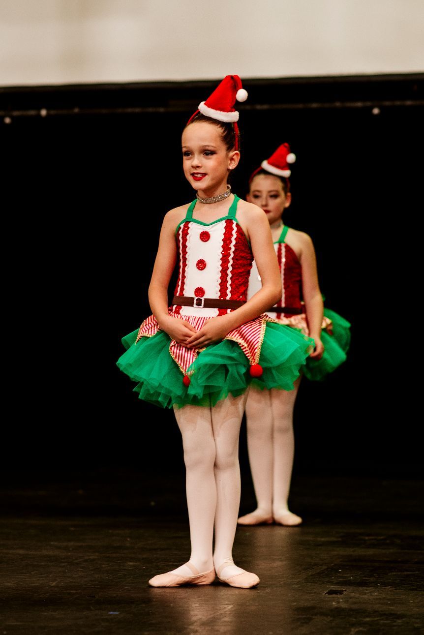 Two Little Girls in Santa Hats Are Dancing on a Stage — Studi-O Dance School In Gateshead, NSW