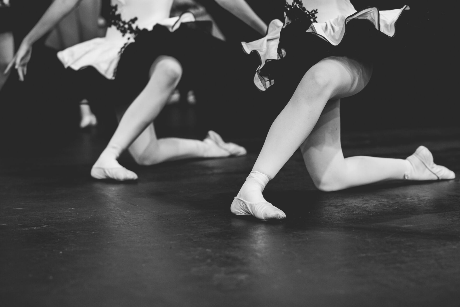 A black and white photo of a group of young girls dancing on a stage — Studi-O Dance School In Gateshead, NSW