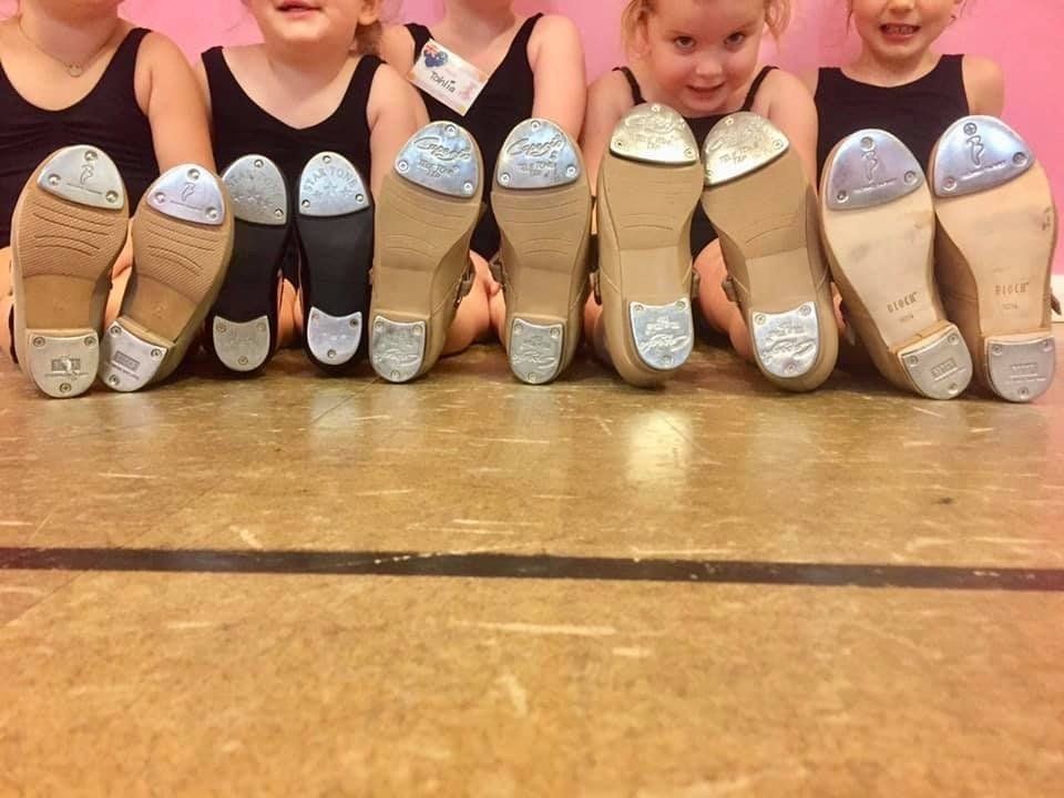 A group of young girls are posing for a picture with their tap shoes on — Studi-O Dance School In Gateshead, NSW