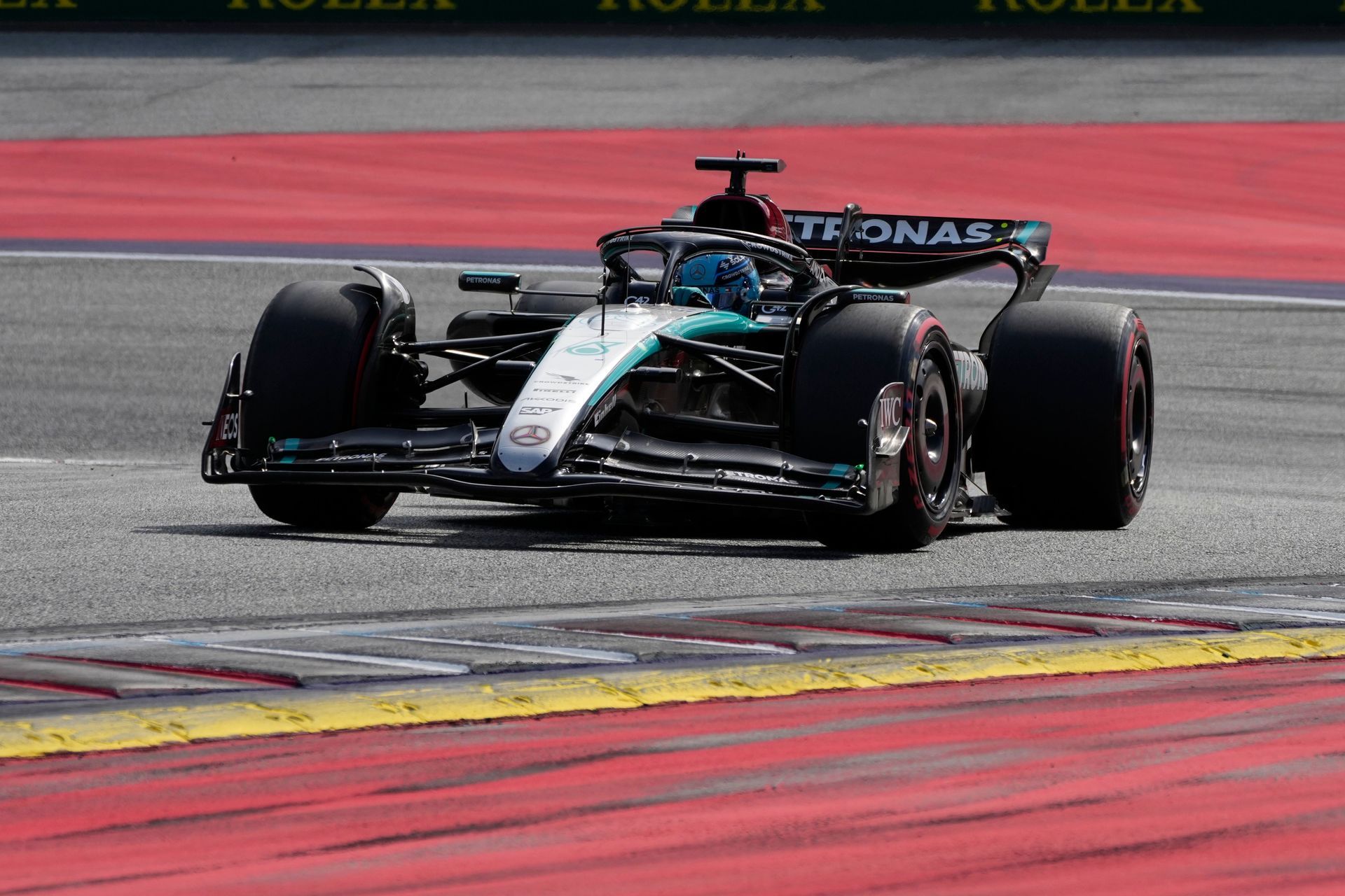 A race car is driving down a race track.