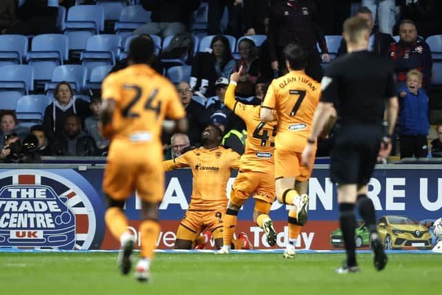 A group of soccer players are celebrating a goal on the field