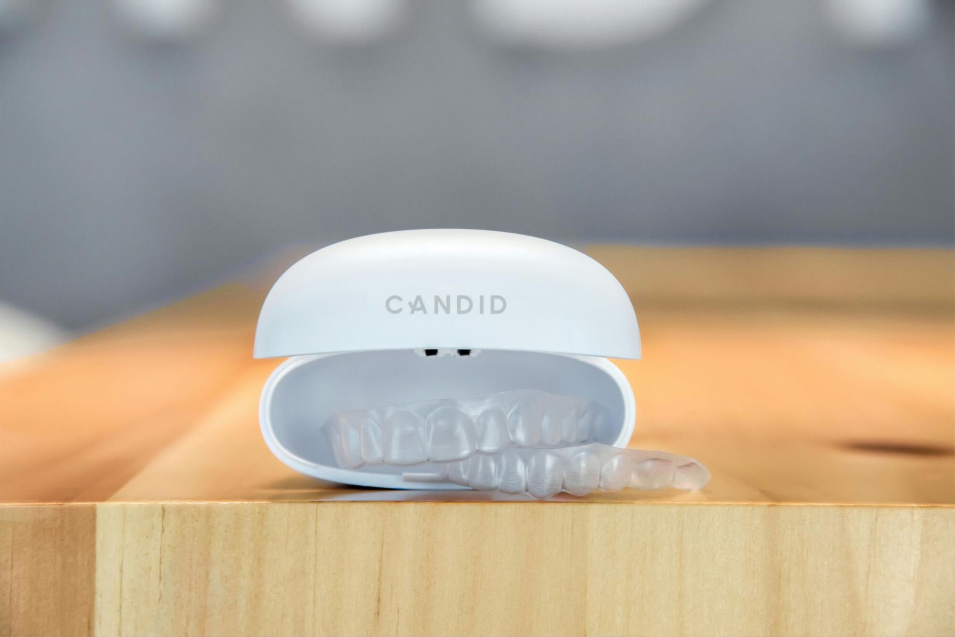 A pair of teeth whitening trays sitting on top of a wooden table.