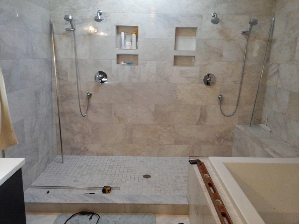 A bathroom with a walk in shower and a bathtub