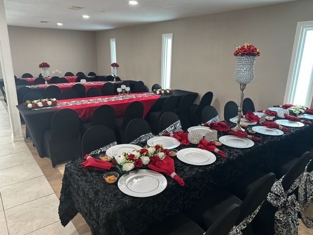 A large room with tables and chairs set up for a party