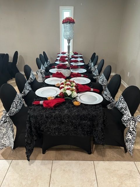 A long table with plates and flowers on it