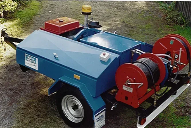 Blue and red utility trailer with two cable reels, emergency light, and storage — Far North Plumbing in Mourilyan, QLD