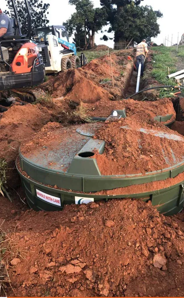 Buried Green AWTS Sewerage Tank at a Construction Site— Far North Plumbing in Mourilyan, QLD