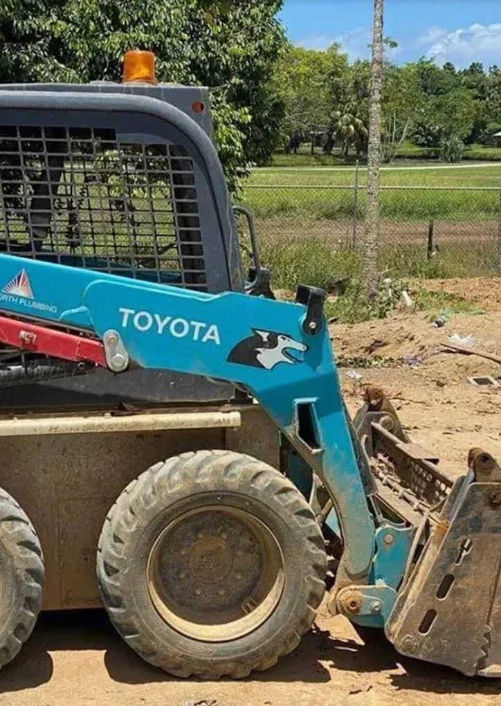 Blue Toyota skid steer loader at a construction site — Far North Plumbing in Mourilyan, QLD