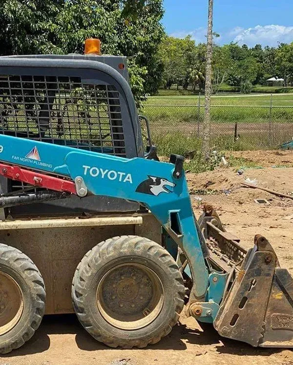 A Blue Toyota Skid Steer Loader on a Dirt Surface — Far North Plumbing in Mourilyan, QLD