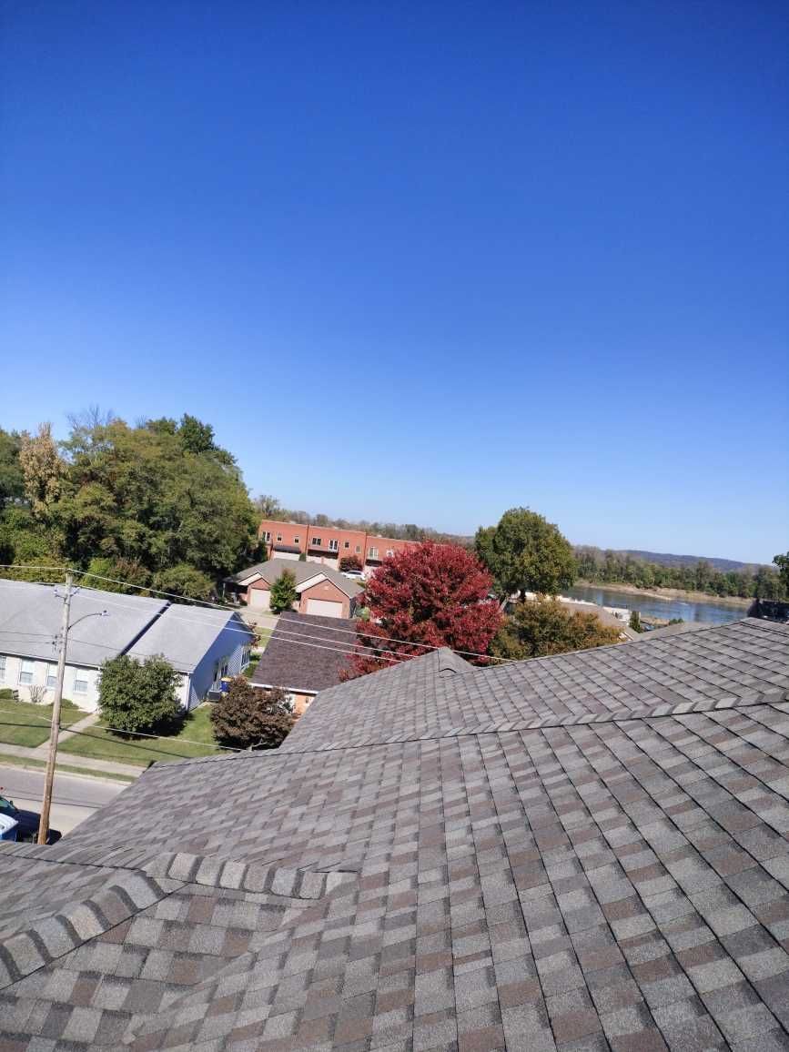 A rooftop view of a residential area with a river in the background.