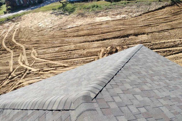 A close up of a roof with a lot of dirt in the background.