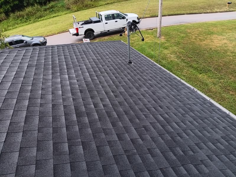 A white truck is parked on the roof of a house.