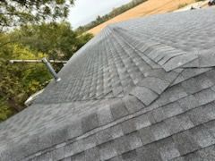 A close up of a roof with a lot of shingles on it.