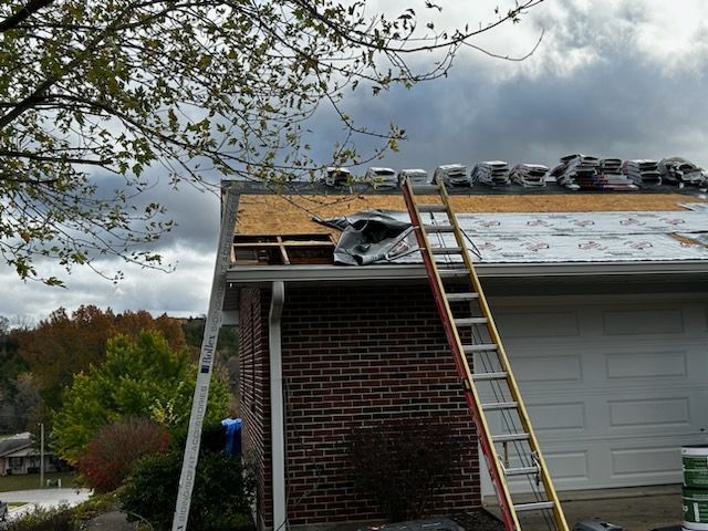 A ladder is sitting on the roof of a house