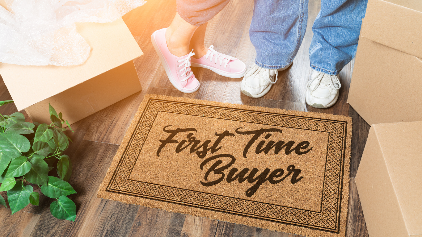 Couple standing on a welcome mat that says