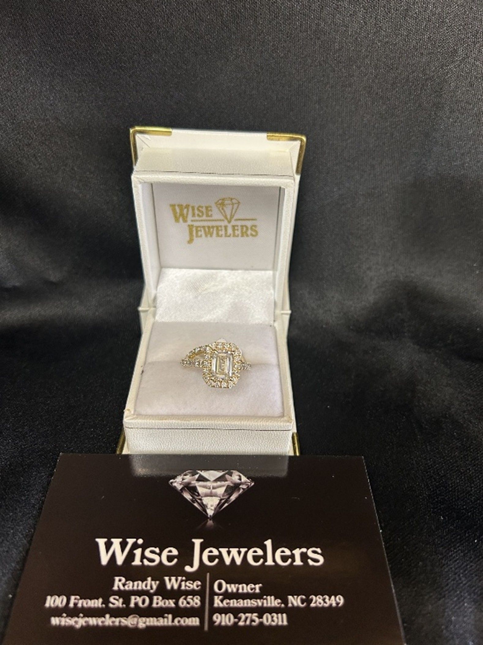 Diamond ring in jewelry box, Wise Jewelers business card.