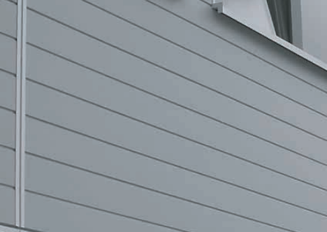 Gray building exterior with horizontal siding.