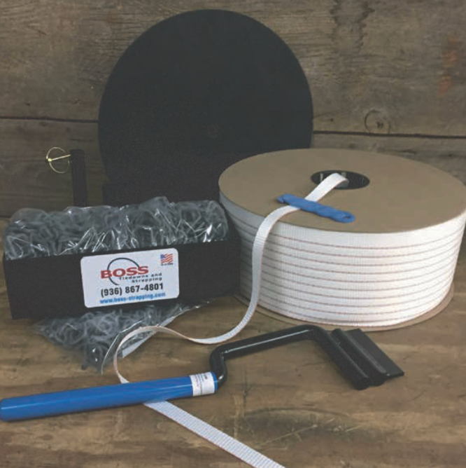 Packaging supplies, including a roll of white banding, clips, a tensioning tool, and a display board.