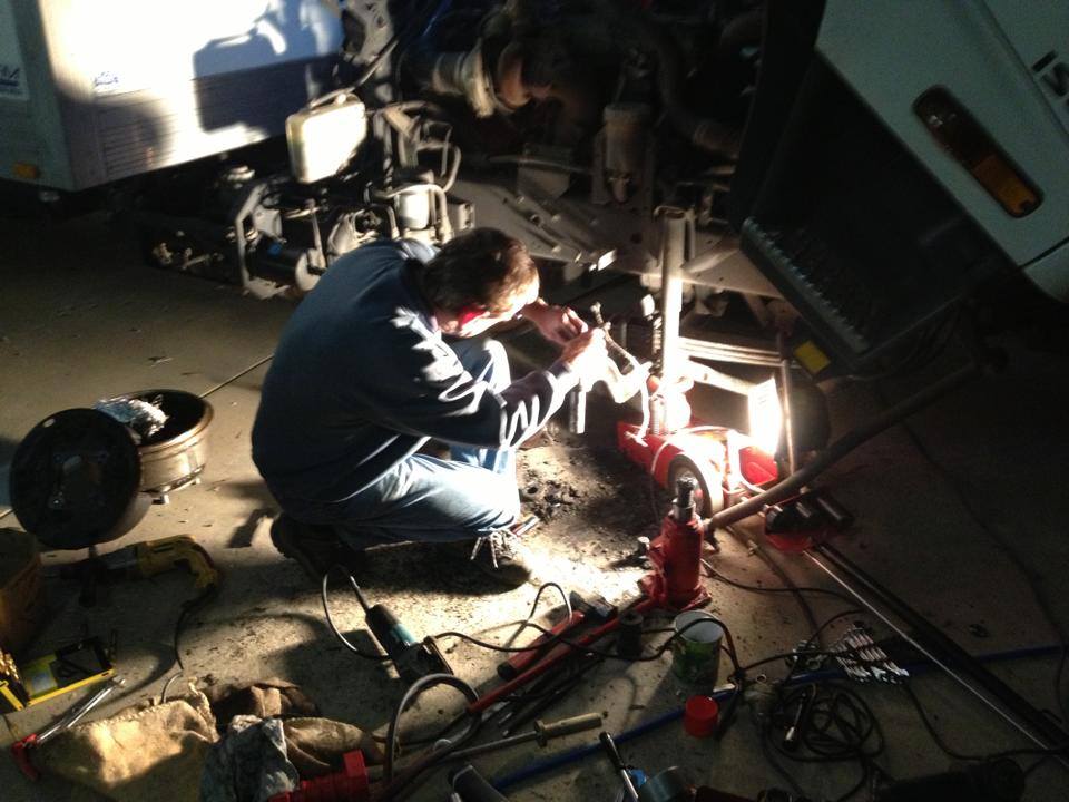 man repairing brakes