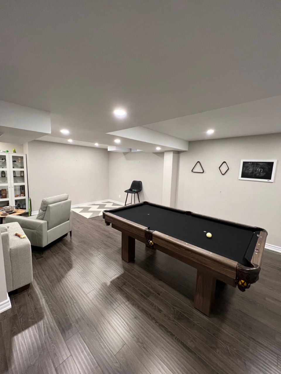 There is a pool table in the middle of the room.
