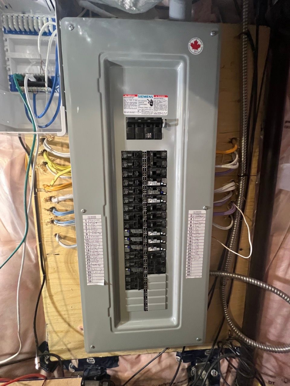 A electrical panel is sitting on a wooden table in a room.