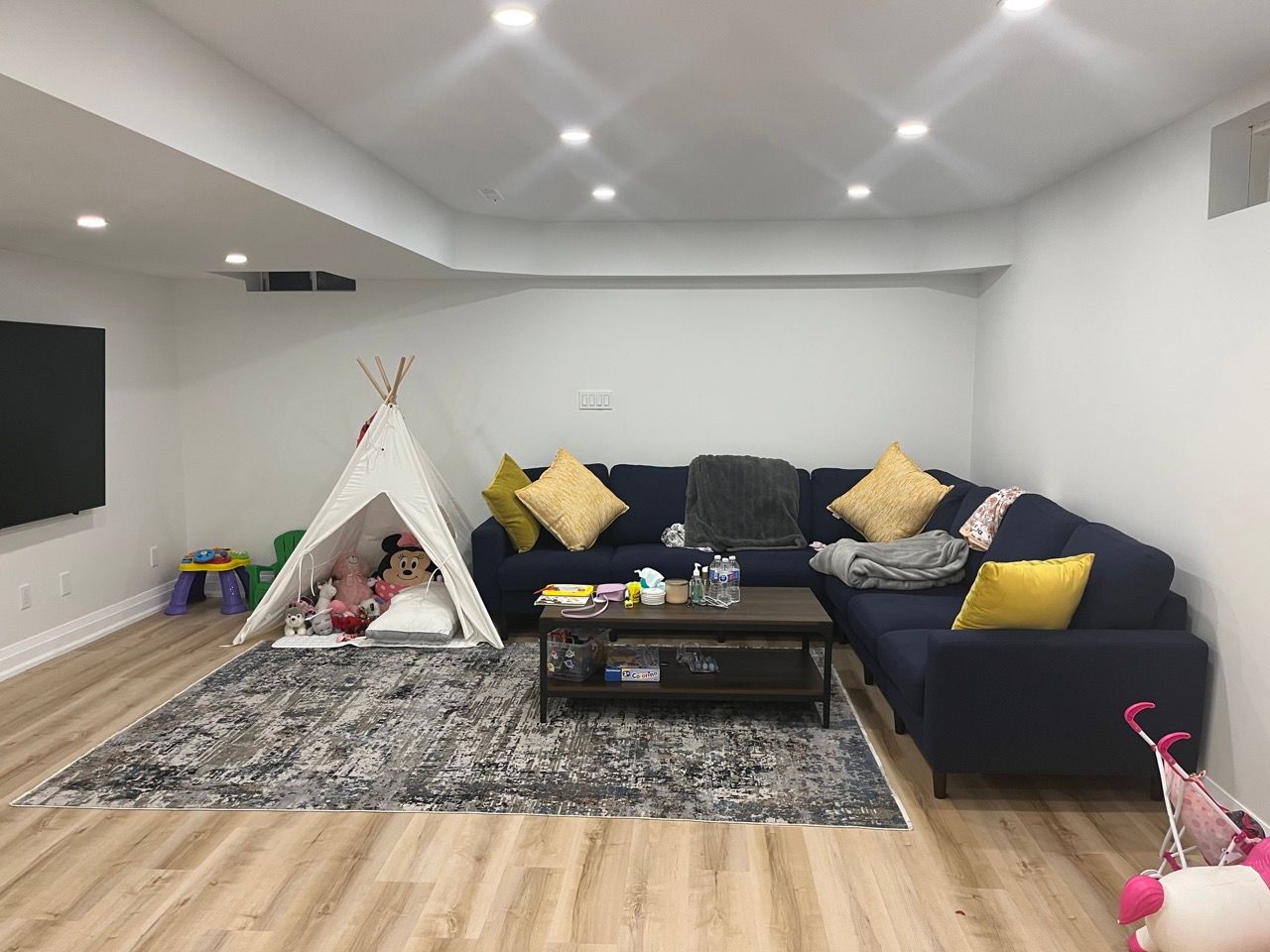 There is a teepee in the middle of the living room.