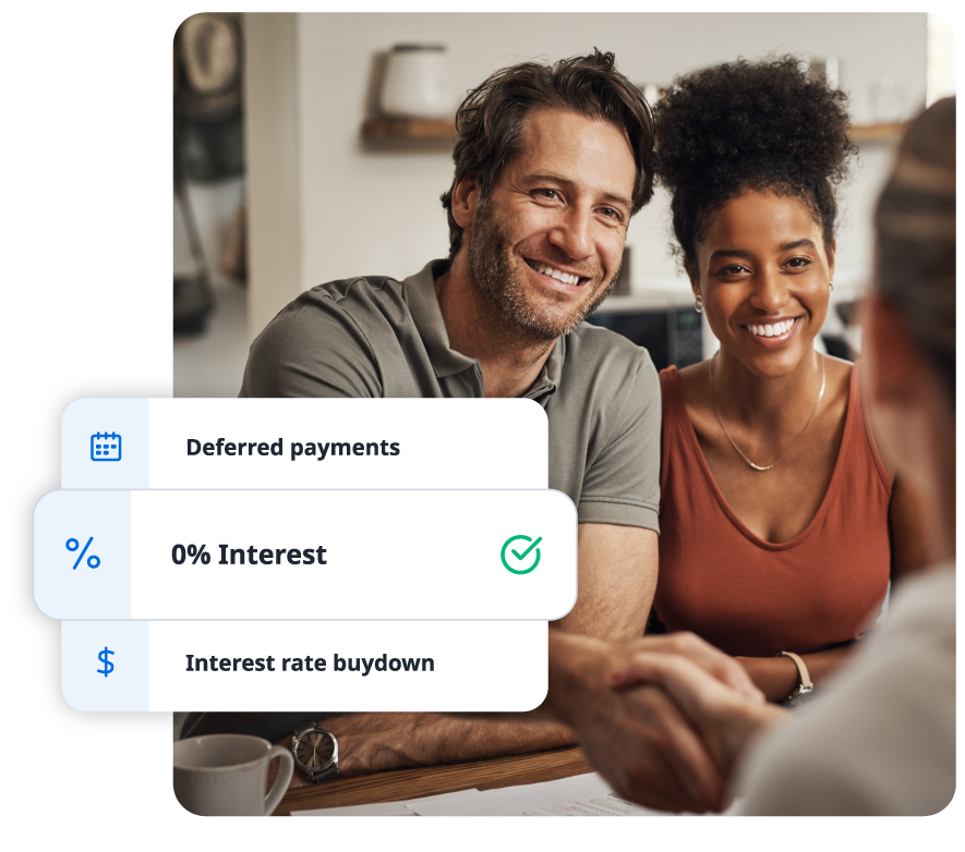 A hand holding a smartphone displaying a smart home app interface; family blurred in background.