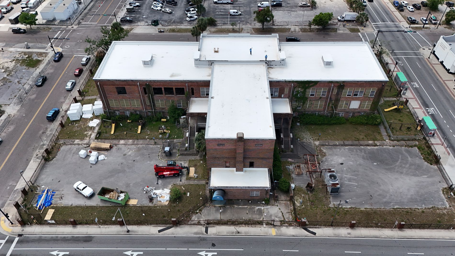 An aerial view of a building with a black roof