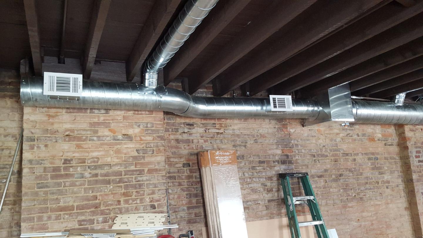 Big Stainless Pipes with Brick Wall — Cumberland, MD — Growden Heating And Cooling