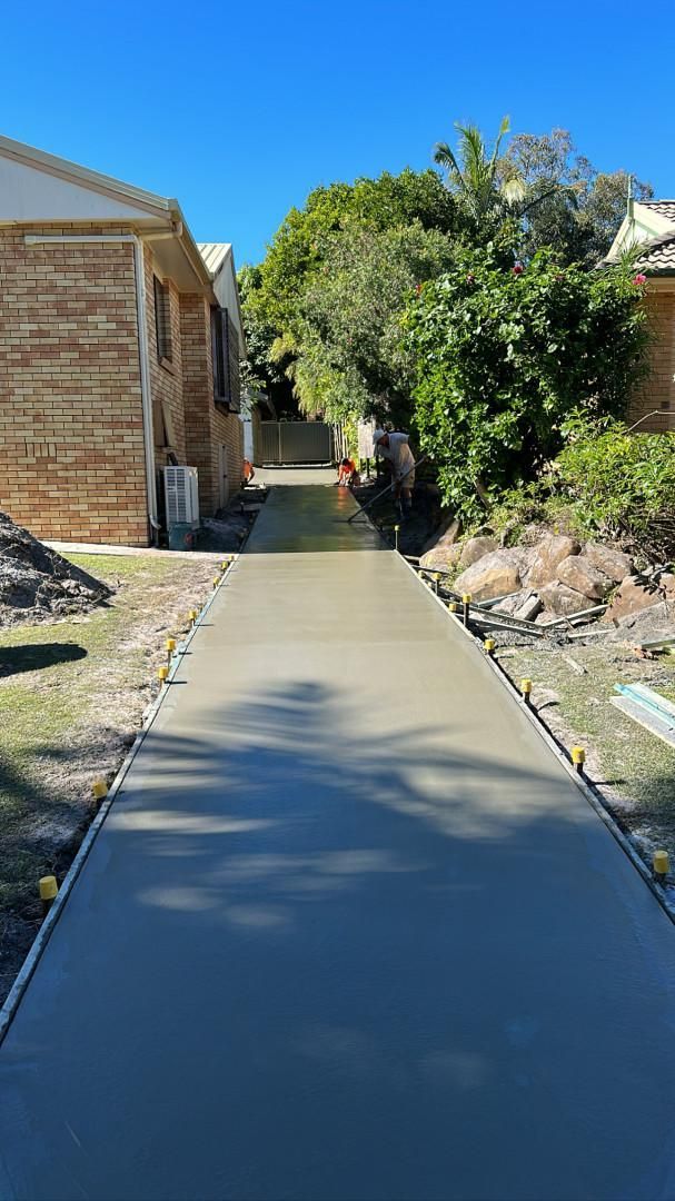 A Concrete Walkway Is Being Built Between Two Houses — Hinterland Concreting Pty Ltd In Lennox Head, NSW