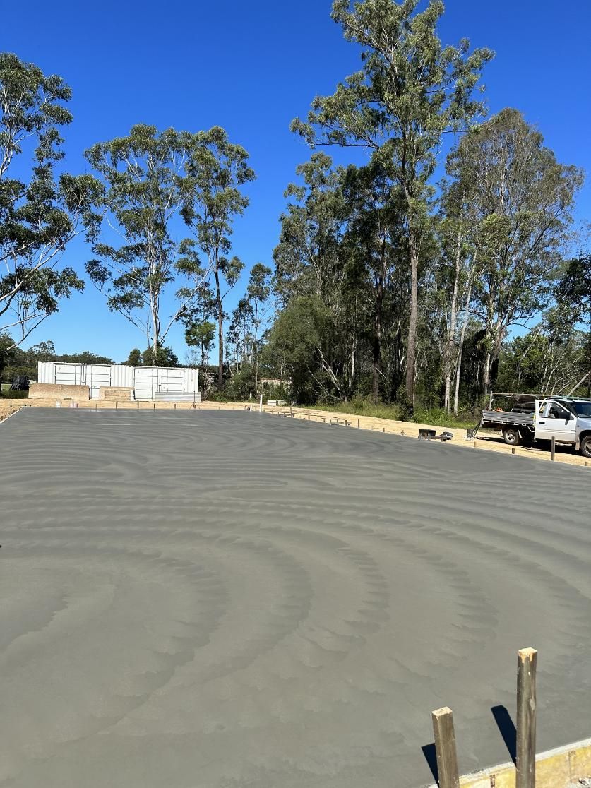 A Concrete Driveway With A Lot Of Trees In The Background — Hinterland Concreting Pty Ltd In Lennox Head, NSW