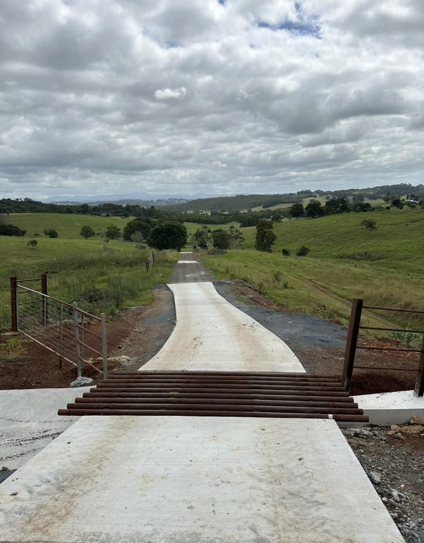 A Concrete Road With A Wooden Bridge — Hinterland Concreting Pty Ltd In Lennox Head, NSW