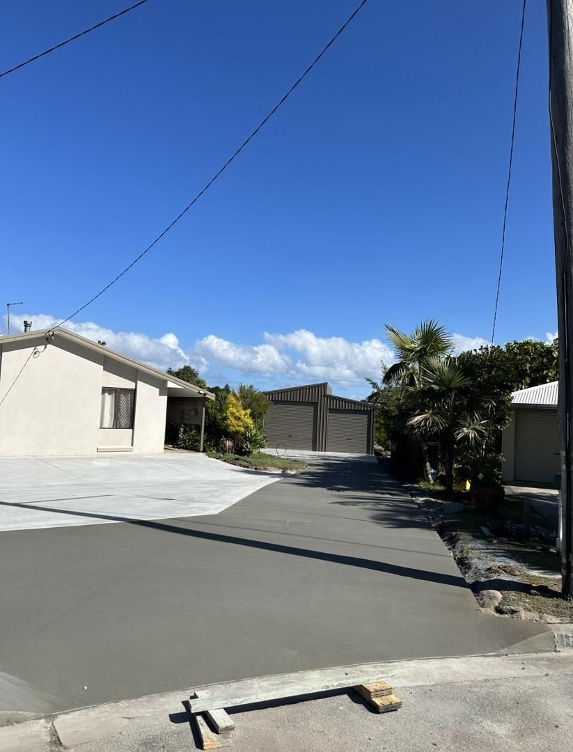 A Concrete Driveway With A House In The Background — Hinterland Concreting Pty Ltd In Lennox Head, NSW